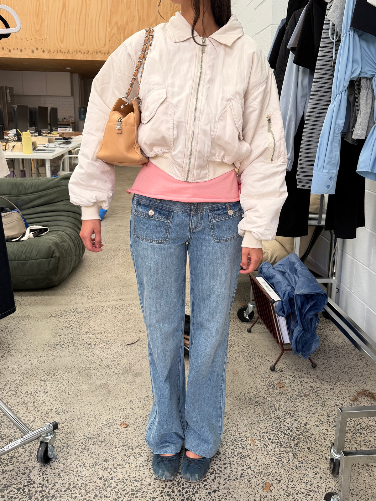 model:S/M/6-10AU H:169CM 
Bone Capsule Bomber, zipped up over a pink top with blue jeans.