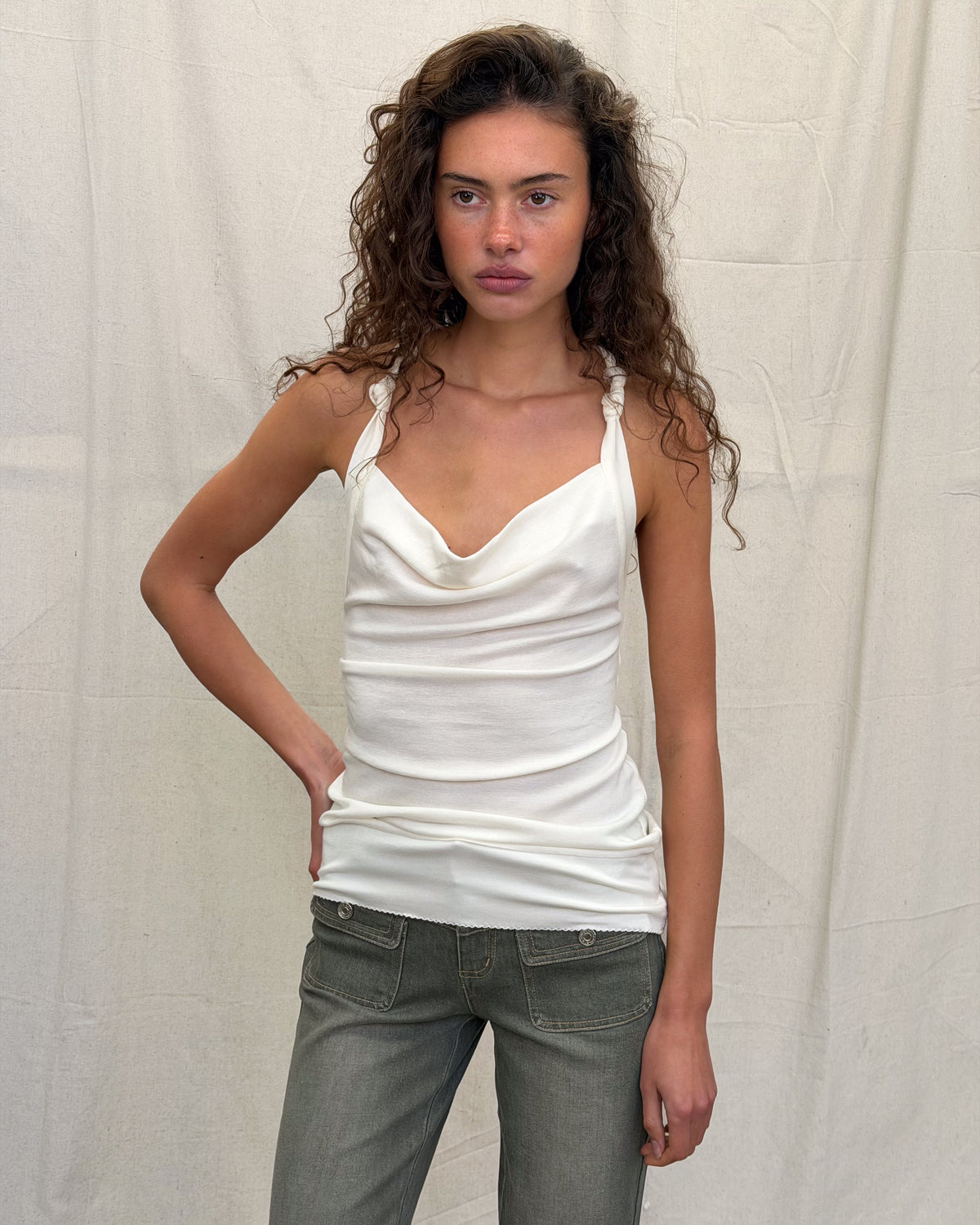 model:S/8AU H:179CM 
White Cowl Knot Tank worn with khaki jeans, showing its draped neckline, knotted straps and longline shape from the front.
