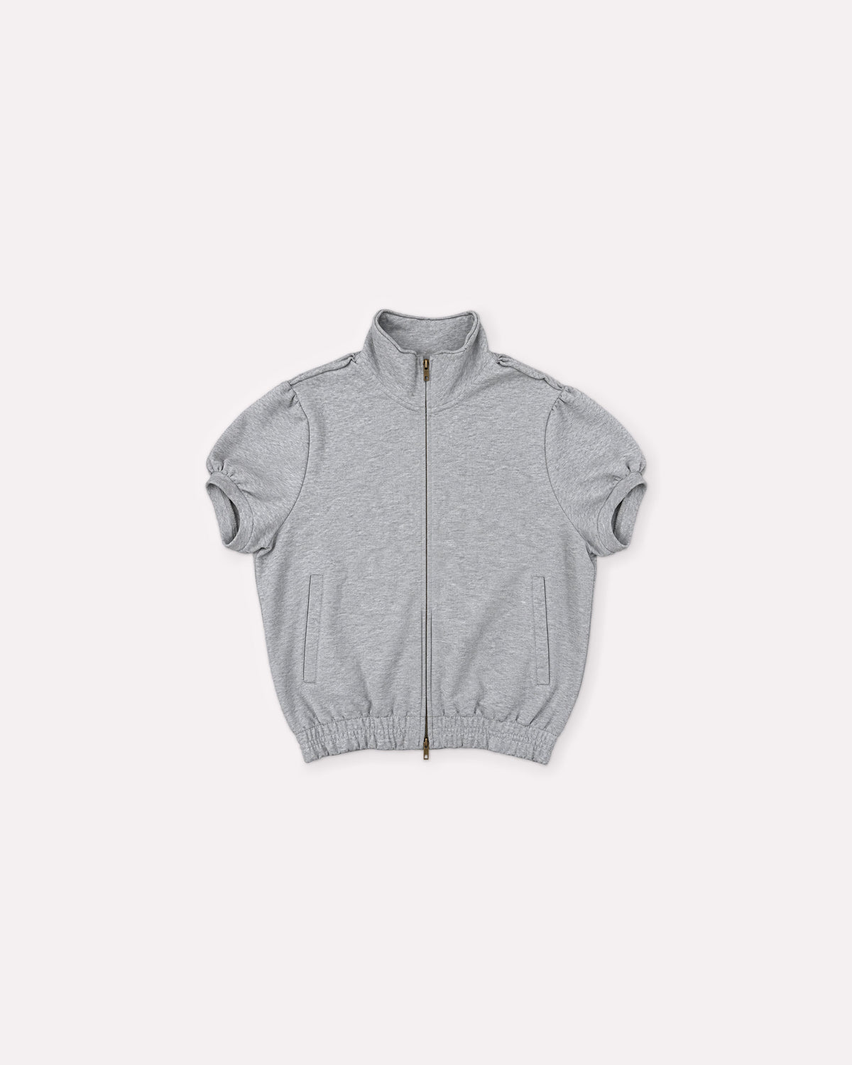 Grey Jersey Zip Top, front flat lay, showing the high neckline, brass zip, puff sleeves, side pockets and elasticated hem.