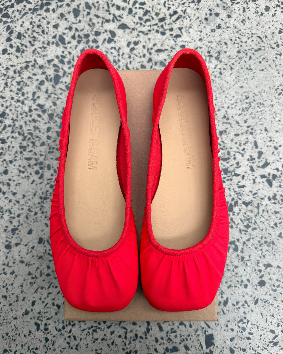 Red Noa Neoprene Ballet Flats, top view of the pair, showing gathered uppers, square toes and tan Scarlet & Sam insoles.