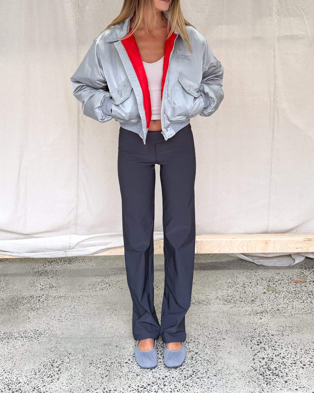 model:S/M/6-10AU H:173CM 
Silver Capsule Bomber, front view, styled with charcoal trousers.