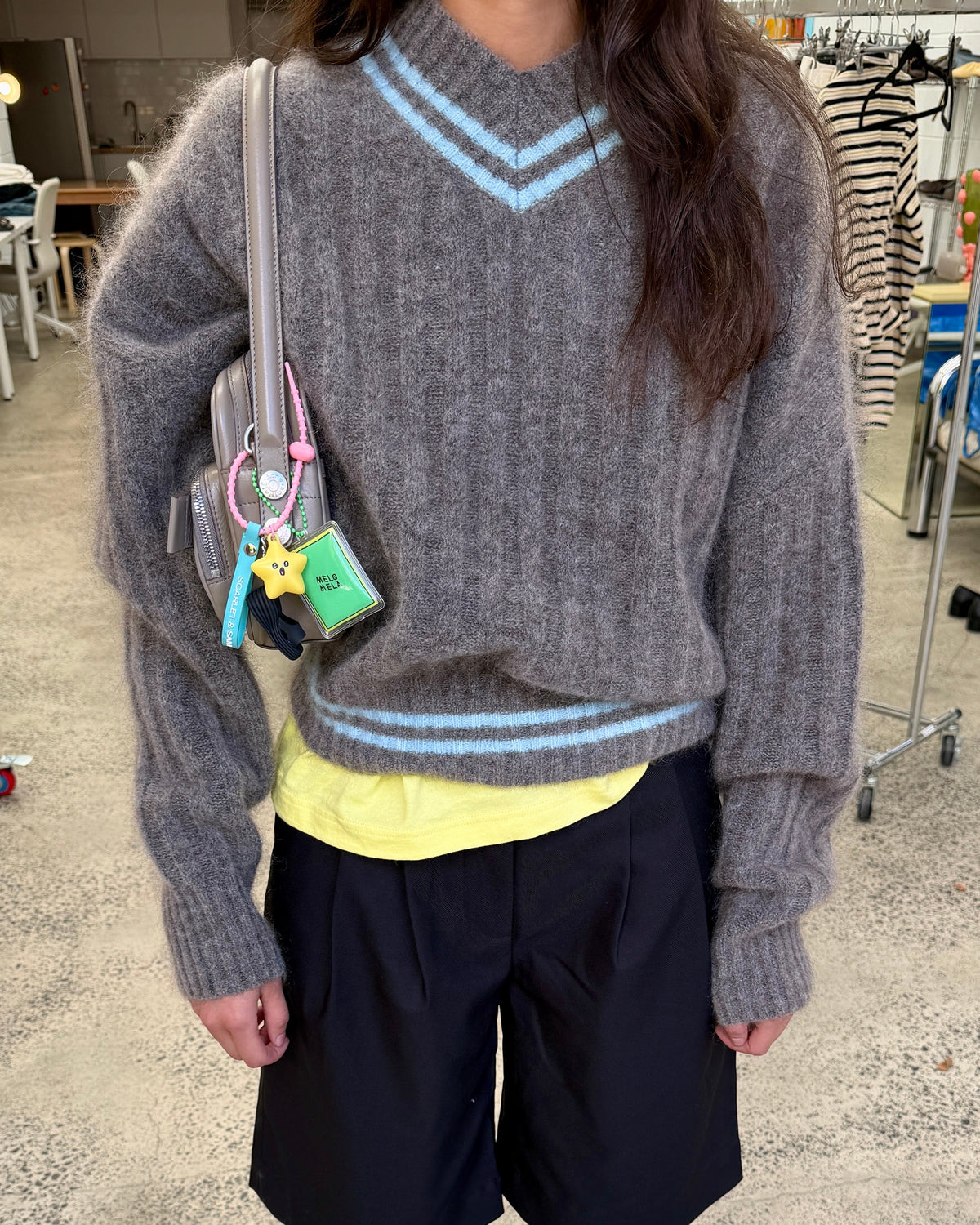 model:S/6-8AU 
Charcoal Mohair Rib Sweater, worn over a yellow top with black shorts.