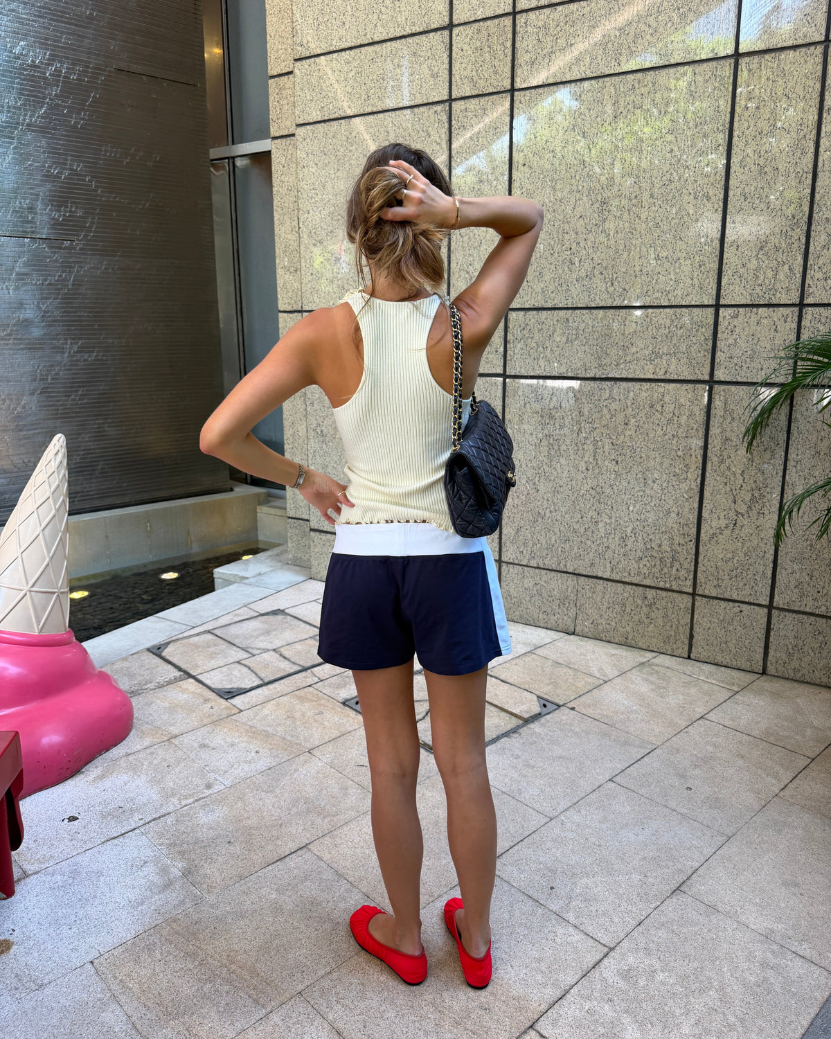 model:S/8AU H:173CM
Cream Ruffle Knit Tank, back view, showing the racerback shape, fine ribbed knit and scalloped hem.