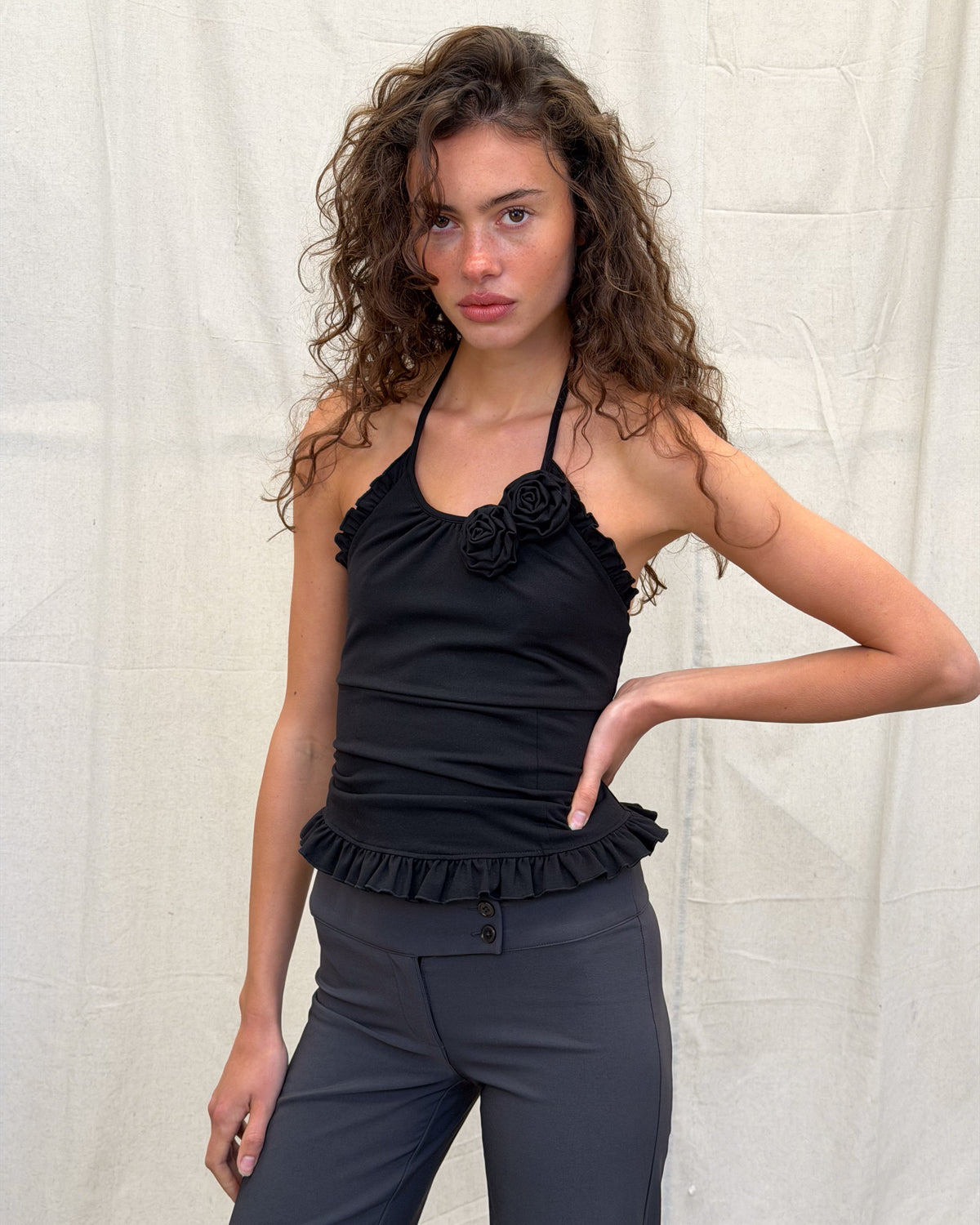 model:XS/6AU H:179CM 
Black Rose Sculpt Halter, front view, styled with charcoal trousers.