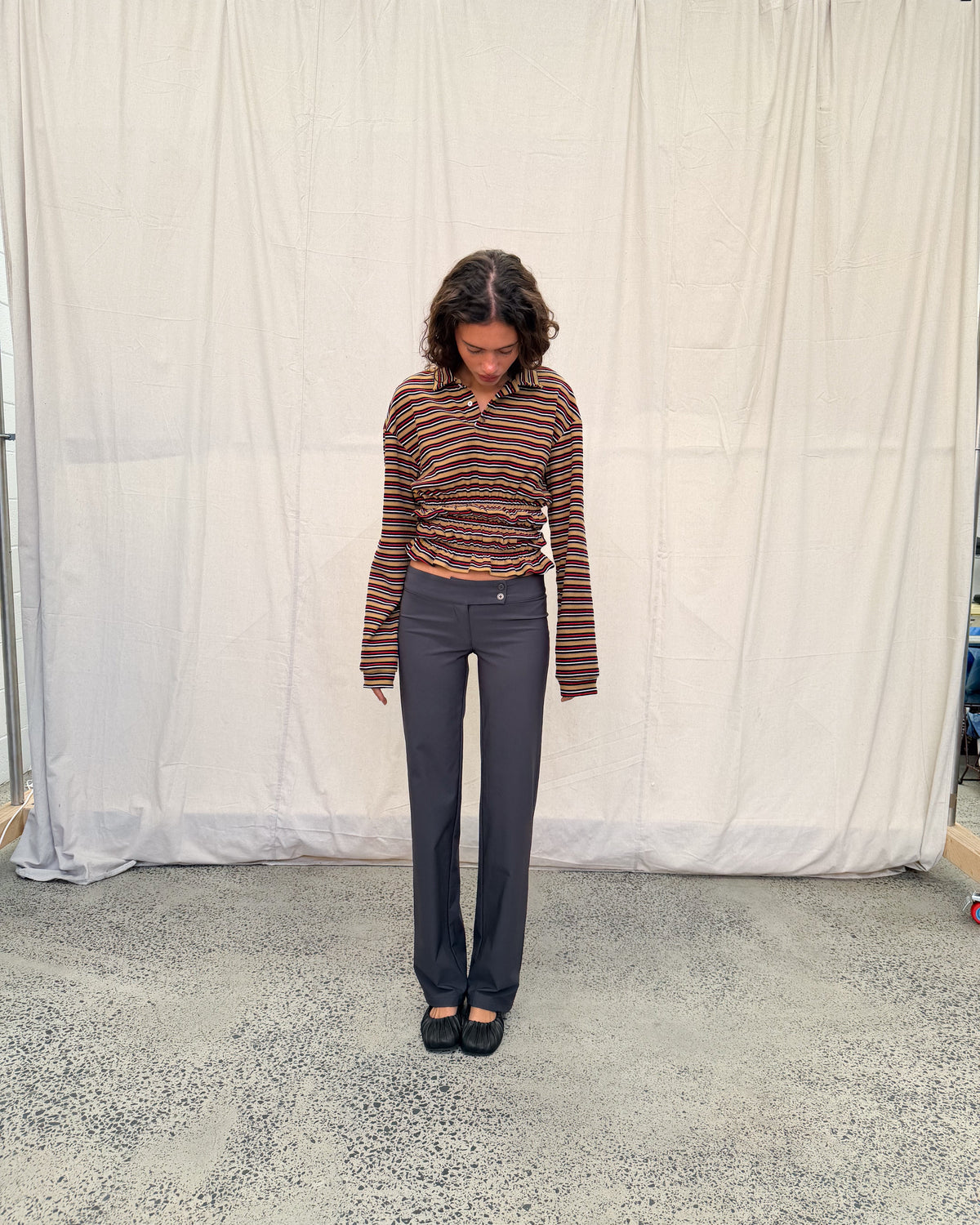 model:XS/6AU H:179CM 
Mustard stripe Eden Rugby Polo, full-length front view, styled with charcoal trousers and black ballet flats.