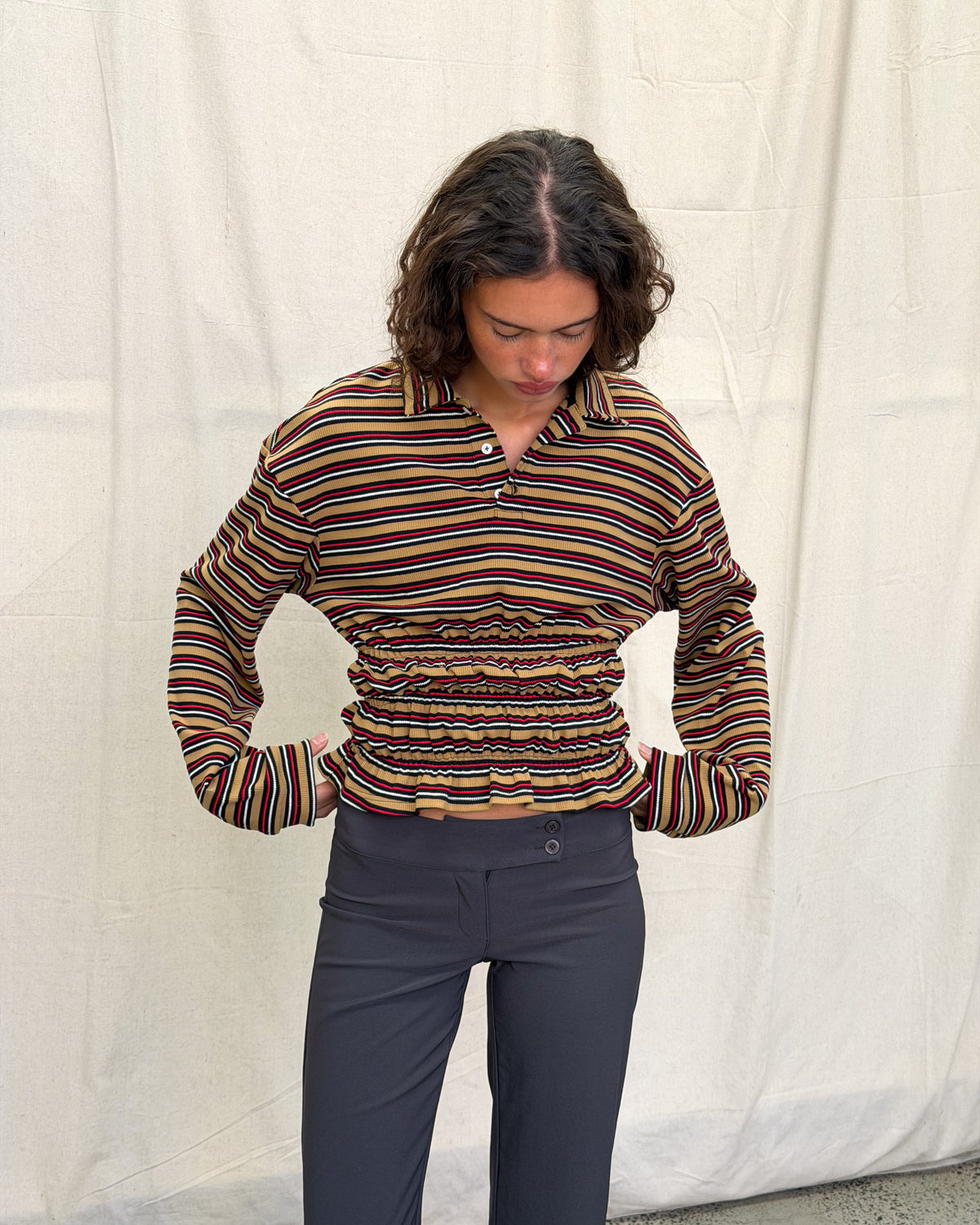 model:XS/6AU H:179CM 
Mustard stripe Eden Rugby Polo, close front view of the striped collar, button placket and gathered waist.