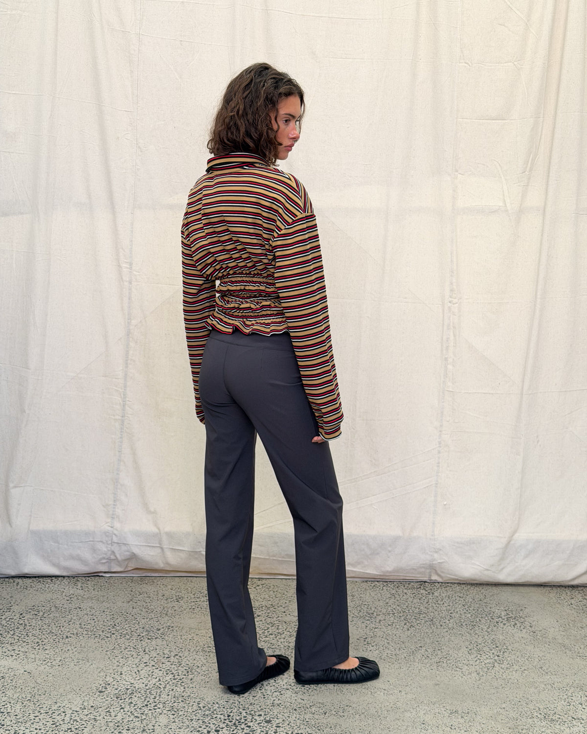 model:XS/6AU H:179CM 
Mustard stripe Eden Rugby Polo, angled back view, showing the gathered waist and extra-long sleeves.