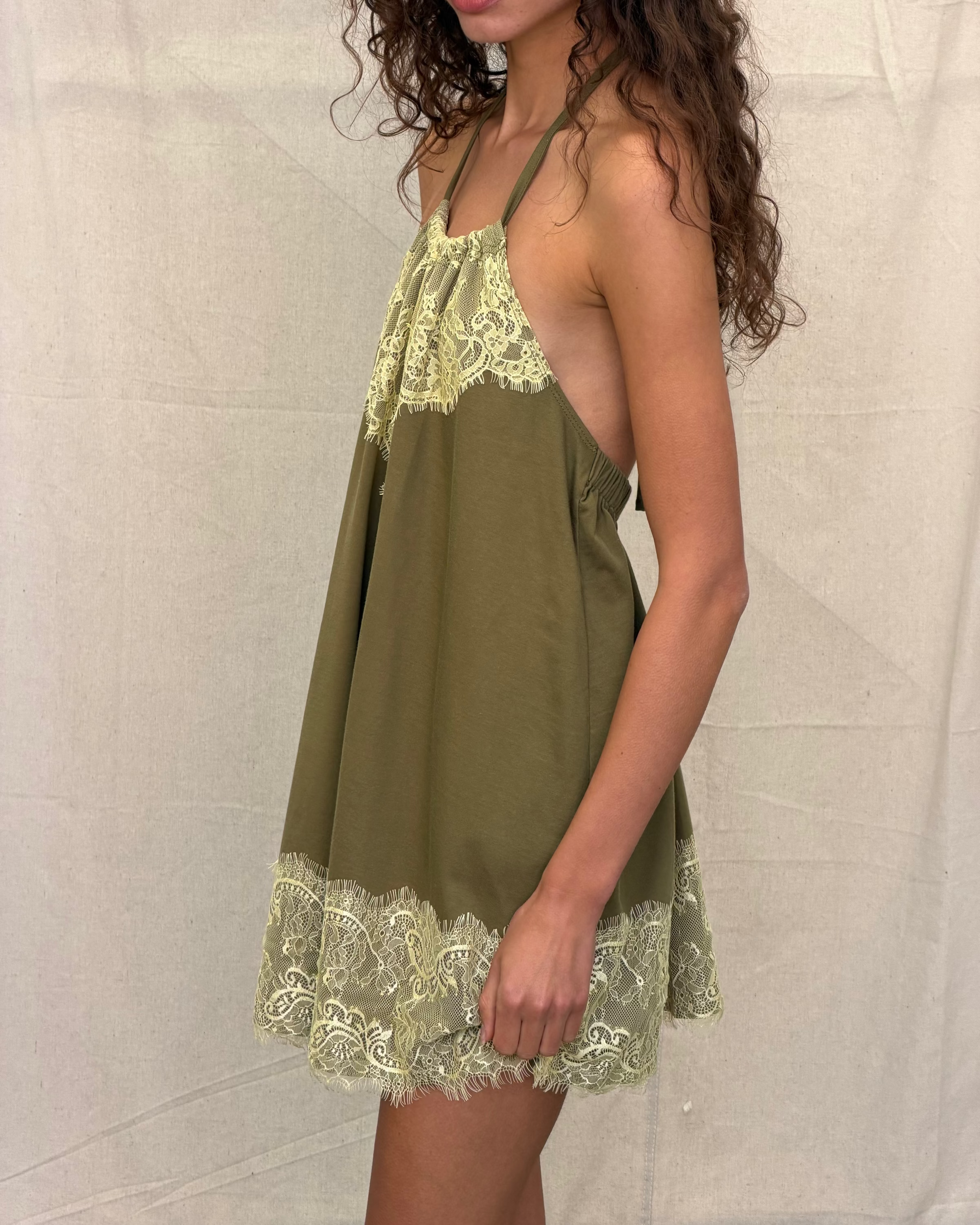model:S/8AU H:179CM 
Khaki Jersey Lace Halter Dress, side close-up on a model, showing the low armhole, draped shape and contrast lace trim.