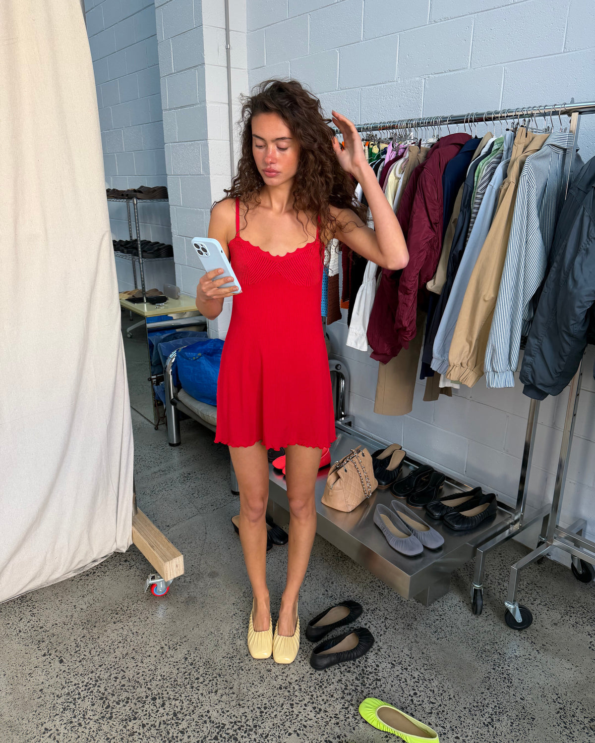 model:XS/6AU
Front view of the red Ribbed Knit Dress with slim straps, a scalloped neckline and mini-length flared skirt, styled with yellow flats.