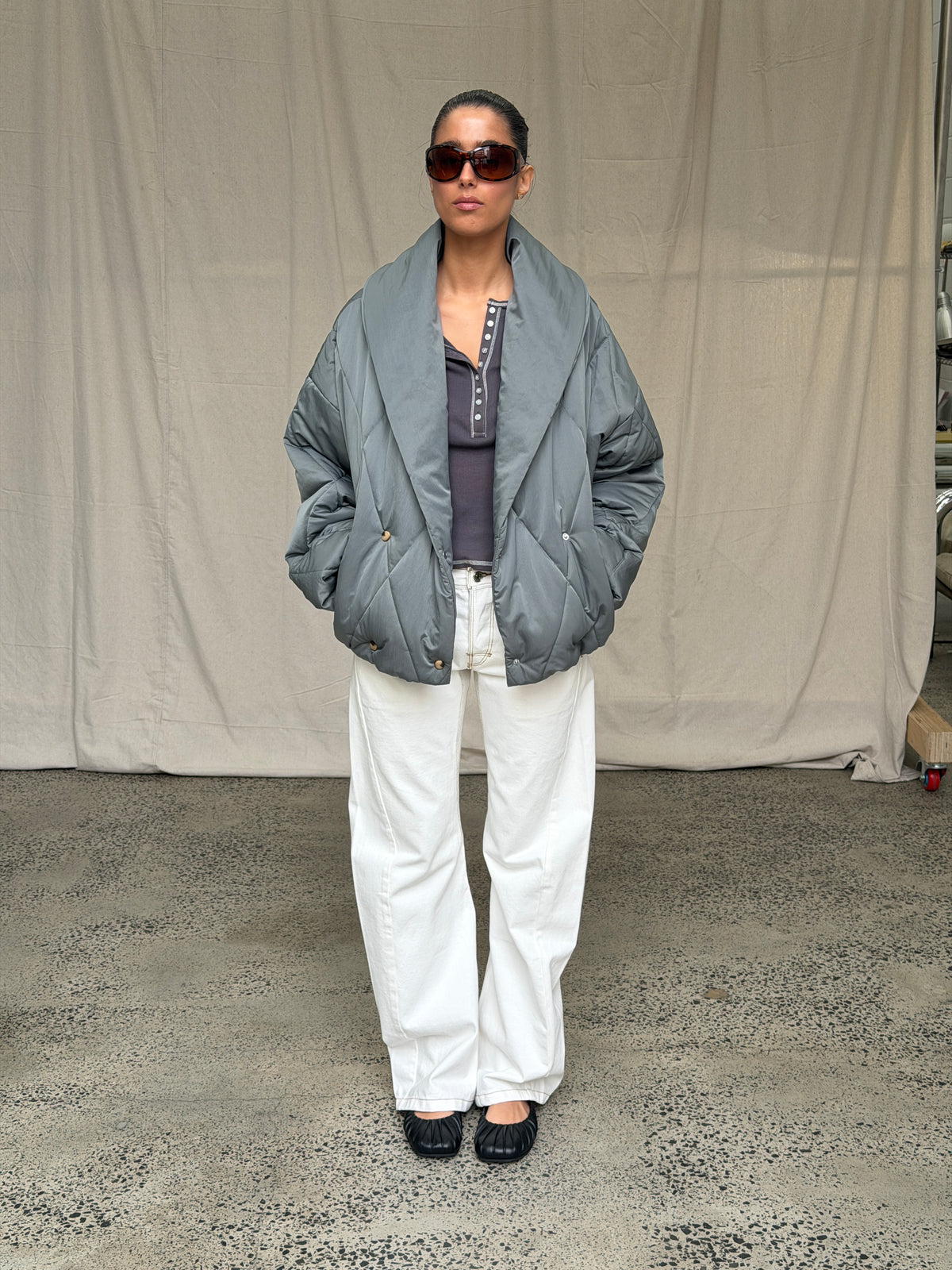 model:S/8AU H:169CM 
White Signature Belted Jeans, full-length view, styled with a charcoal bomber.