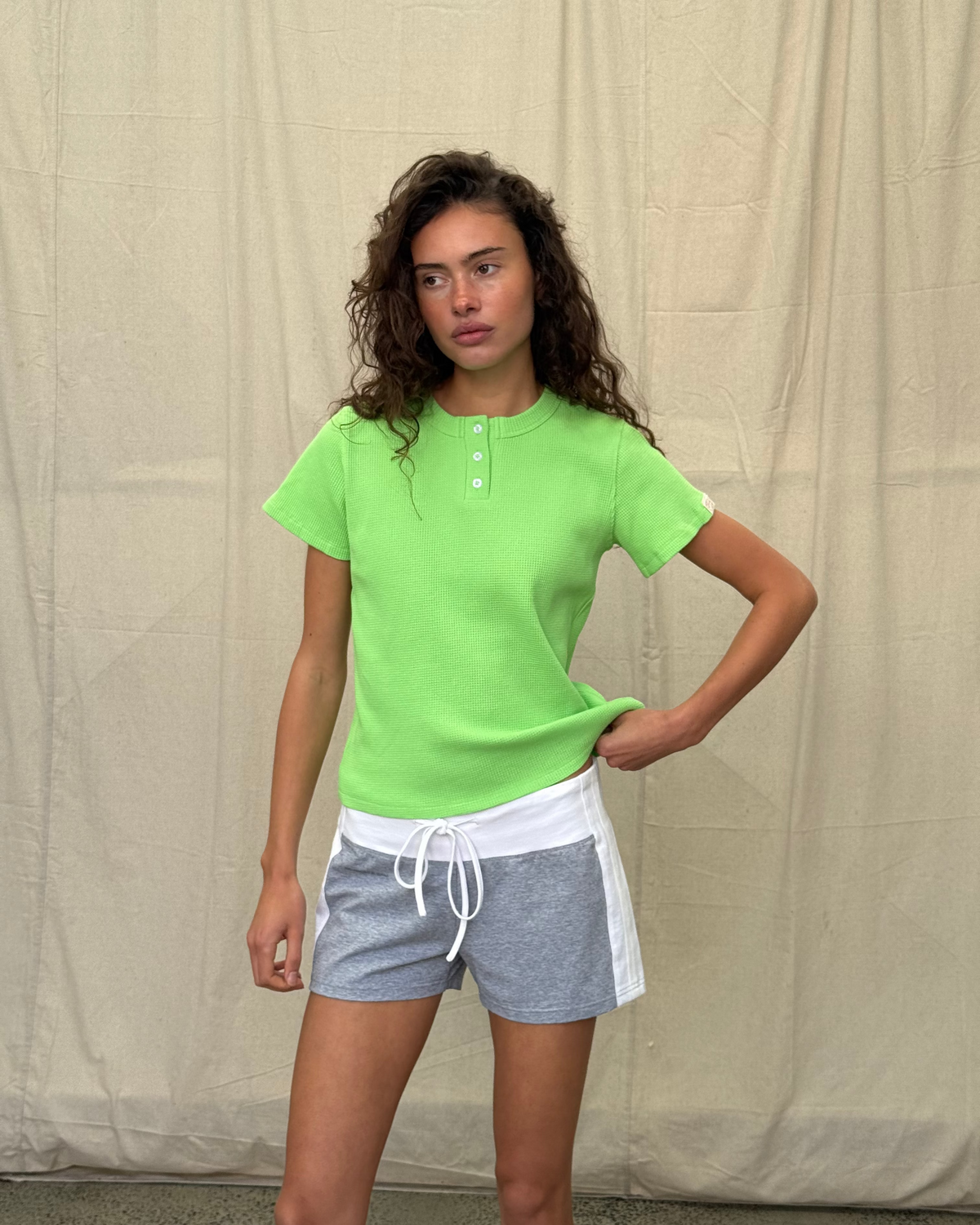 model:S/8AU H:179CM 
Scarlet & Sam lime Waffle Tee on a model, front view showing short sleeves and a Henley button placket.