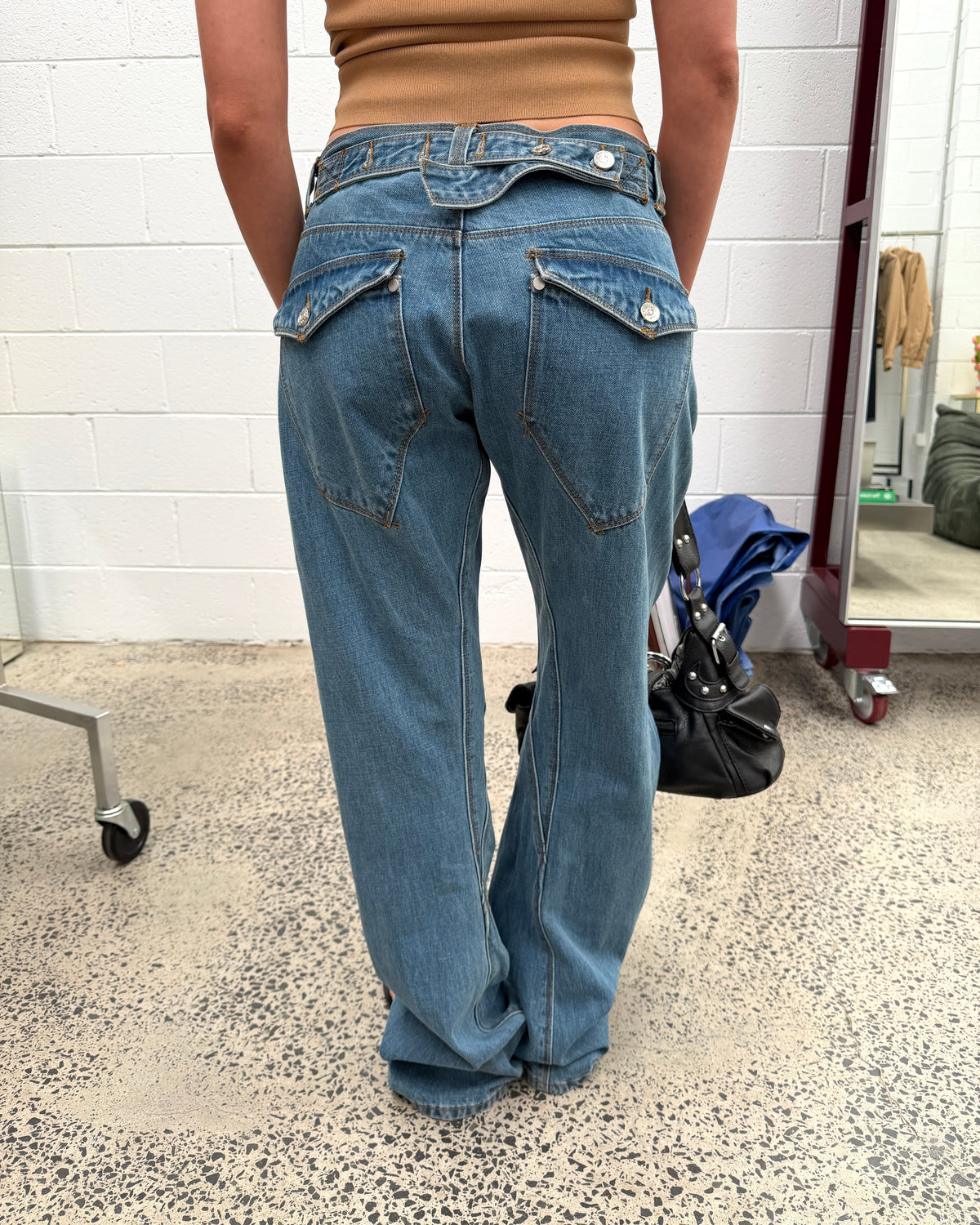 model:S/8AU H:164CM 
Mid Blue Signature Belted Jeans, back detail, showing the belt and angled pocket flaps.