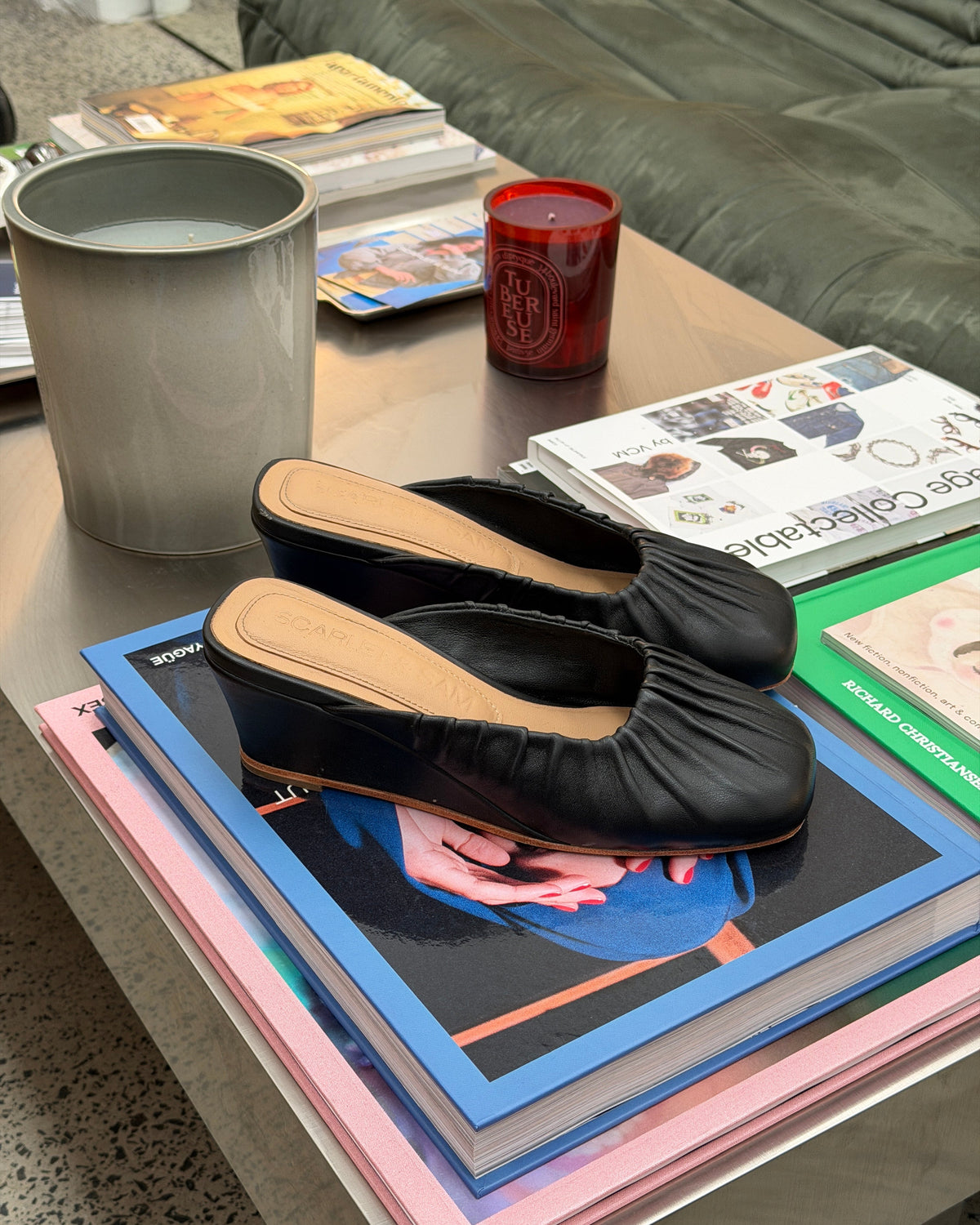 Black Noa Ballet Wedge, pair resting on books, showing the open-back design.