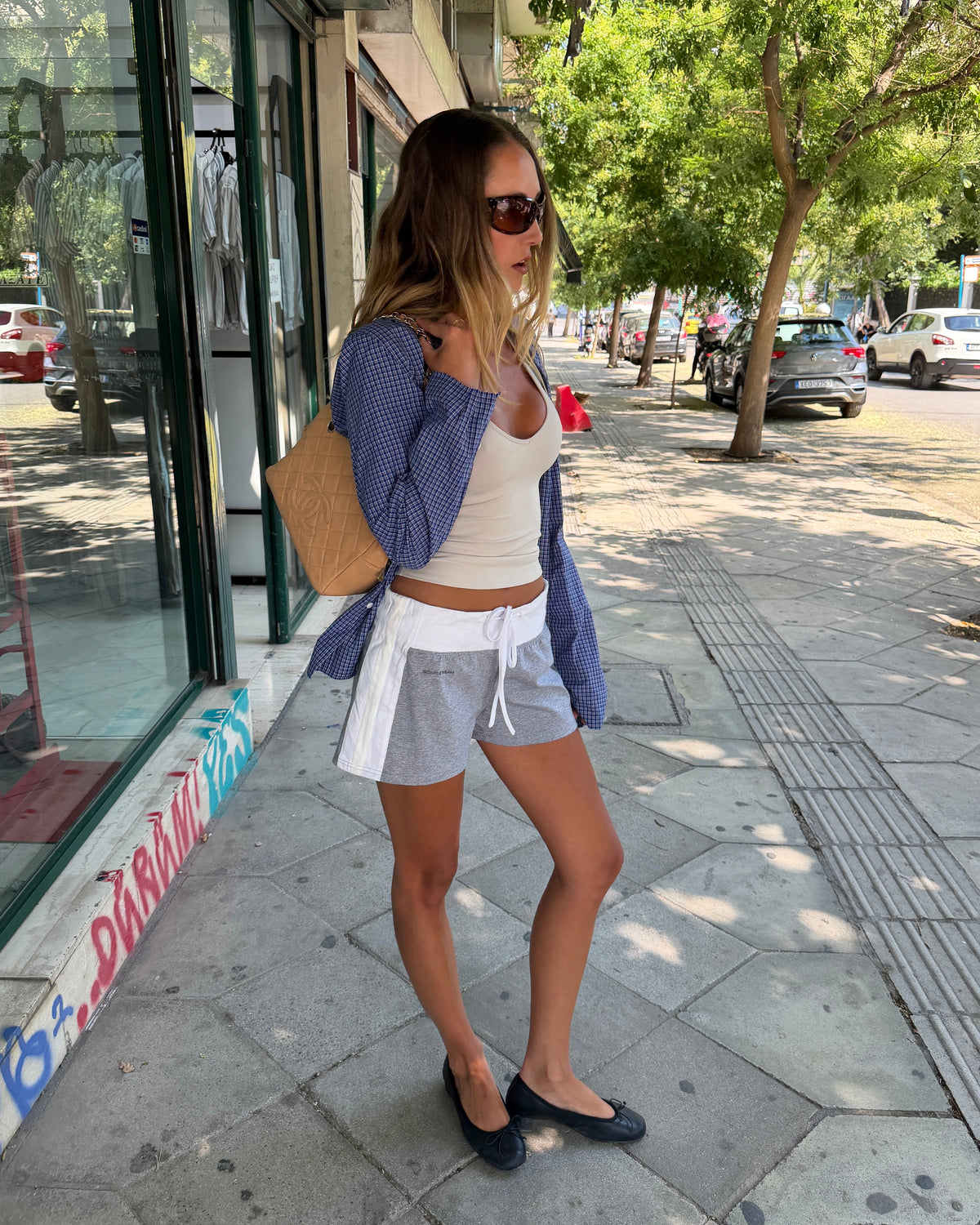 model:XS/6AU H:173CM 
Grey Jersey Mini Short, front view on a model, showing the white drawstring waistband and contrast side panels.